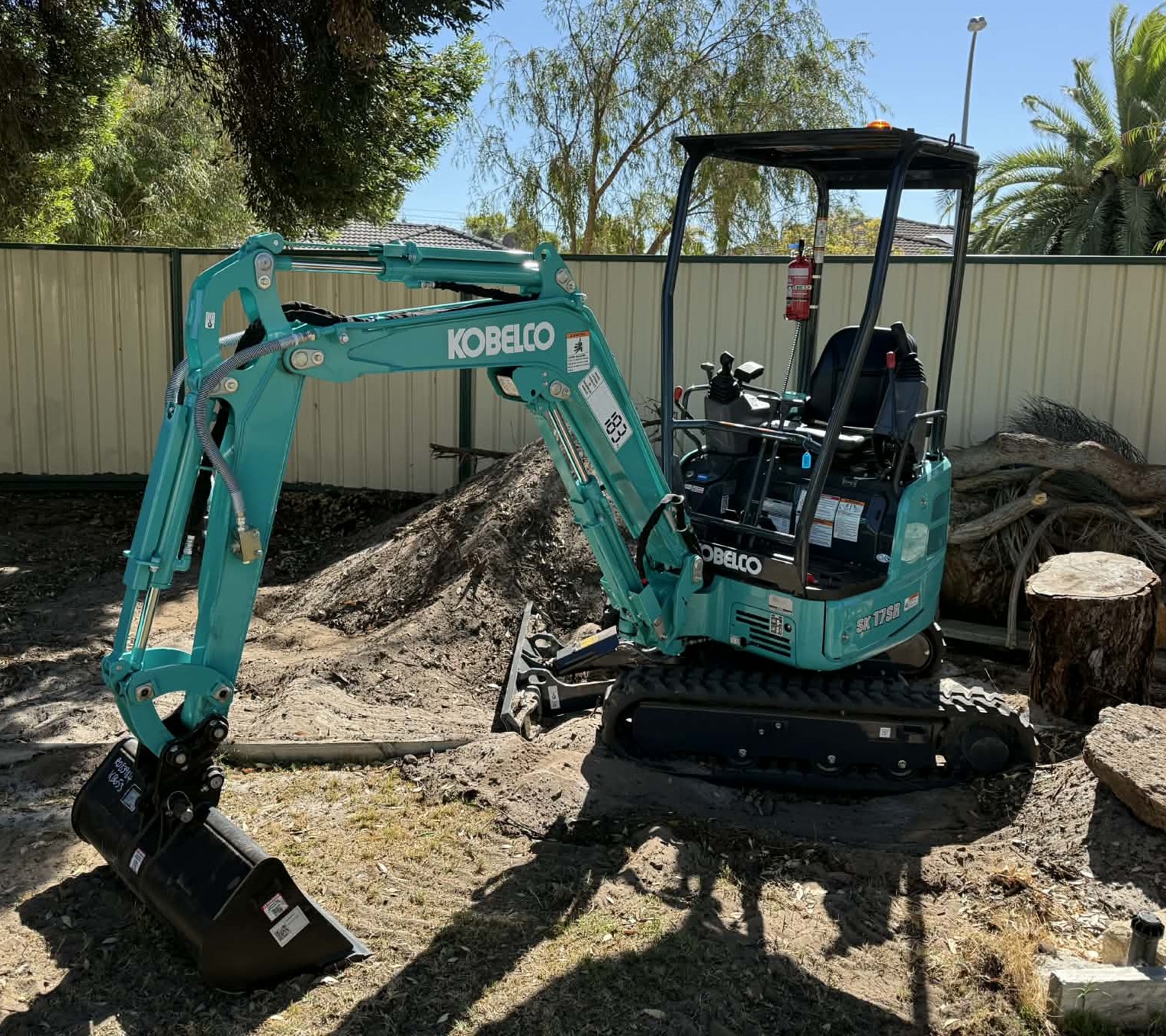 Mini excavator working cleanly in a residential yard